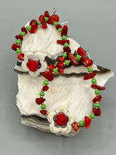 Load image into Gallery viewer, These bamboo coral red stone chip beaded hoop earrings feature green and gold glass, while a white magnesite flower pendant and quartzite rose beads add detail. Measurements: 3" length  
