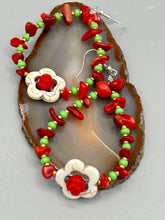 Load image into Gallery viewer, These bamboo coral red stone chip beaded hoop earrings feature green and gold glass, while a white magnesite flower pendant and quartzite rose beads add detail. Measurements: 3" length  
