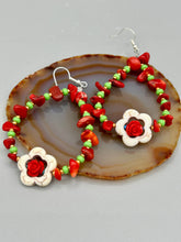 Load image into Gallery viewer, These bamboo coral red stone chip beaded hoop earrings feature green and gold glass, while a white magnesite flower pendant and quartzite rose beads add detail. Measurements: 3" length  
