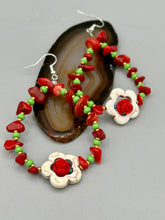 Load image into Gallery viewer, These bamboo coral red stone chip beaded hoop earrings feature green and gold glass, while a white magnesite flower pendant and quartzite rose beads add detail. Measurements: 3" length  
