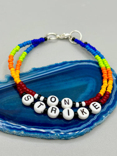 Rainbow Pride beaded bracelet ON STRIKE Metal wire with hook-eye clasp.