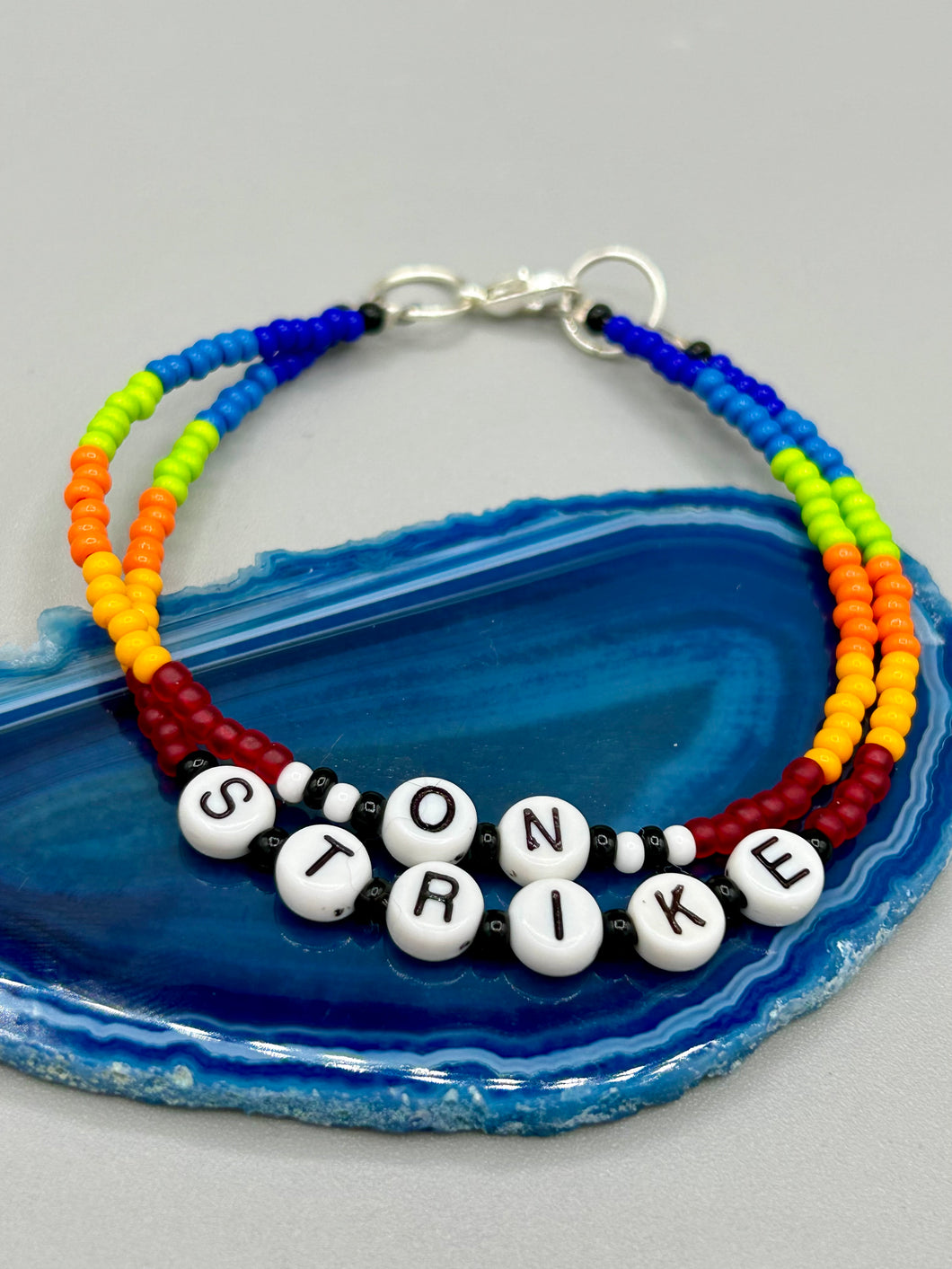 Rainbow Pride beaded bracelet ON STRIKE Metal wire with hook-eye clasp.
