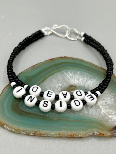 This set of Sarcastic Beaded Bracelets features fun and fashionable accessories perfect for any occasion. Crafted from metal wire and equipped with a hook-eye clasp, these sassy, sarcastic bracelets come in black and white and rainbow style. They are sure to make a statement. A fun addition to any accessory collection.   Measurements:  Black and White Color 