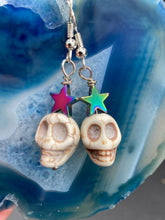 Load image into Gallery viewer, Howlite Skull Beads Earrings With Large Star Shapes Rainbow Hematite Bead. Versatile style, pastel goth, celestial stardust, witchy, day of the dead. You can dress these up or down, it will definitely give your outfit a unique look.   Measurements: 1 ” in length
