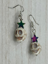 Load image into Gallery viewer, Howlite Skull Beads Earrings With Large Star Shapes Rainbow Hematite Bead. Versatile style, pastel goth, celestial stardust, witchy, day of the dead. You can dress these up or down, it will definitely give your outfit a unique look.   Measurements: 1 ” in length
