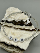 Load image into Gallery viewer, Hand beaded bracelet with clear and silver glass beads, Zen letters Metal wire with hook-eye clasp.

