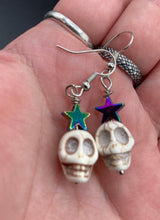 Load image into Gallery viewer, Howlite Skull Beads Earrings With Large Star Shapes Rainbow Hematite Bead. Versatile style, pastel goth, celestial stardust, witchy, day of the dead. You can dress these up or down, it will definitely give your outfit a unique look.   Measurements: 1 ” in length
