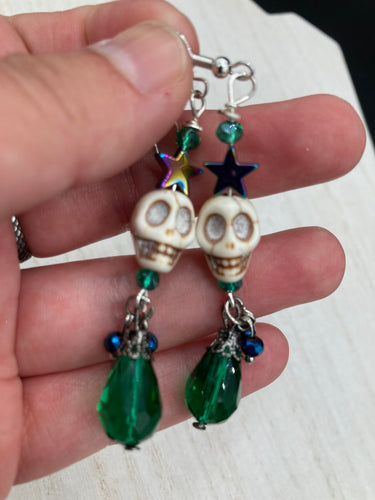 Mini Howlite Skull Bead Earrings large star shaped rainbow hematite bead with a large bright green teardrop shaped glass bead on the bottom of the skull for max shimmer and movement. Ultimate Chingona, Cabrona, Latina Chicana, Goth, Vampire Goth, Dark Witchy, La Bruja Style. You can dress these up or down, it will definitely give your outfit a unique look. You can dress these up or down, it will definitely give your outfit a unique look.  Measurements: 2 ” in length