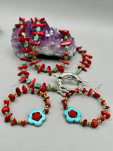 Load image into Gallery viewer, These bamboo coral red stone chip earrings feature tiny turquoise, green, and gold glass beading. Accenting the vibrant design is a turquoise flower pendant with quartzite rose beads for added detail.  Measurements: 2 1/4" length 
