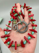 Load image into Gallery viewer, This uniquely designed Southwestern Style necklace is a mesmerizing blend of large bamboo red coral beads as well as turquoise and gold glass beads. The finishing touch is a beautiful large serpent toggle clasp.    Measurements:   Necklace is 25 1/2 " in length 
