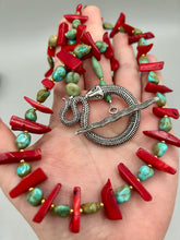 Load image into Gallery viewer, This uniquely designed Southwestern Style necklace is a mesmerizing blend of large bamboo red coral beads as well as turquoise and gold glass beads. The finishing touch is a beautiful large serpent toggle clasp.    Measurements:   Necklace is 25 1/2 " in length 
