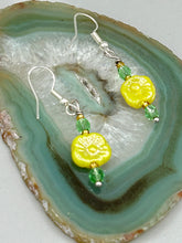 Load image into Gallery viewer, This delicate jewelry displays an array of gentle hues, vibrant yet soft.This light yellow pressed glass floral beaded bracelet and earrings set features an iridescent shimmer finish and is crafted with metal wire and a lobster claw clasp for easy closure. Measurements:  Bracelet: 8 1/2&quot; in length   Earrings: 1 1/4&quot; length
