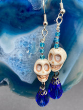 Load image into Gallery viewer, Mini Howlite Skull Bead Earrings and large bright blue teardrop shaped glass bead for major shimmery movement. Ultimate Chingona, Cabrona, Latina Chicana, Goth, Vampire Goth, Dark Witchy, La Bruja Style. You can dress these up or down, it will definitely give your outfit a unique look.   Measurements: 2 ” in length
