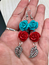 Load image into Gallery viewer, This alluring set of earrings captures the vibrant, enchanting beauty of the desert, featuring blue turquoise and bright red accents, highly detailed quartize rose beads and intricate silver plated leaf, providing fun movement. Perfect for those who love the Southwestern feel, Dia De Los Muertos, they can be dressed up or down, giving your fashion a unique touch.  Measurements: 2” in length
