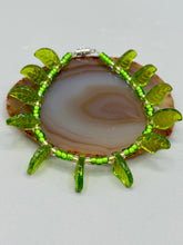 Load image into Gallery viewer, This nature-inspired jewelry is crafted from shimmering glass beads in shades of light and dark green as well as clear iridescent and gold tones. Light and dark green glass leaf beaded anklet and earrings provide intricate detailing. Crafted with metal wire and a barrel screw clasp, they offer a secure fit.
