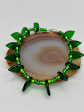Load image into Gallery viewer, This nature-inspired jewelry is crafted from shimmering glass beads in shades of light and dark green as well as clear iridescent and gold tones. Light and dark green glass leaf beaded anklet and earrings provide intricate detailing. Crafted with metal wire and a barrel screw clasp, they offer a secure fit.
