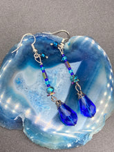 Load image into Gallery viewer, This beautifully and bold set of glass beaded earrings were inspired by the vibrant and beautiful colors of the galaxy and the cosmos full of colors that makes a stunning statement piece of jewelry. Rectangular rainbow Hematite beads add a different texture to the style. This is a bold piece of jewelry, a “must have”to your collection.   Measurements: 2” in length
