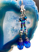 Load image into Gallery viewer, This beautifully and bold set of glass beaded earrings were inspired by the vibrant and beautiful colors of the galaxy and the cosmos full of colors that makes a stunning statement piece of jewelry. Rectangular rainbow Hematite beads add a different texture to the style. This is a bold piece of jewelry, a “must have”to your collection.   Measurements: 2” in length
