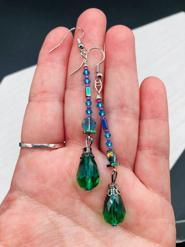 Created with Nature in Mind - Peacock Feathers Inspire These Earrings. Showcase a unique combination of glass beading and rectangular rainbow Hematite beads for a multi-textured look. An eye-catching style and a 
