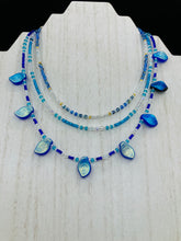 Load image into Gallery viewer, This exquisite Winter Frost Nature Inspired Jewelry has all your style needs covered. A detailed, glass beaded necklace featuring an array of blues, silver and gold tones adorns your neck to add a touch of elegance to any look. Effortlessly dress it up or down to complement any ensemble.  Measurements:  Necklace is 14” in length, can be adjusted up to 18"
