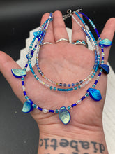 Load image into Gallery viewer, This exquisite Winter Frost Nature Inspired Jewelry has all your style needs covered. A detailed, glass beaded necklace featuring an array of blues, silver and gold tones adorns your neck to add a touch of elegance to any look. Effortlessly dress it up or down to complement any ensemble.  Measurements:  Necklace is 14” in length, can be adjusted up to 18"
