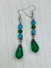 Load image into Gallery viewer, ﻿Beautiful and bold set of glass beaded earrings were inspired by the stunning and vibrant peacock feathers, full of color that makes a unique statement piece of jewelry.  The primary color is the bright green glass beads that contain hues of blues, purples, and a tint of gold to complement each other and I added a different size and shape beads to create texture to the style. This is a bold piece of jewelry, a “must have” to your collection.   Measurements: 2” in length
