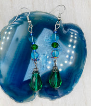 Load image into Gallery viewer, ﻿Beautiful and bold set of glass beaded earrings were inspired by the stunning and vibrant peacock feathers, full of color that makes a unique statement piece of jewelry.  The primary color is the bright green glass beads that contain hues of blues, purples, and a tint of gold to complement each other and I added a different size and shape beads to create texture to the style. This is a bold piece of jewelry, a “must have” to your collection.   Measurements: 2” in length
