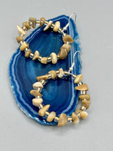 Load image into Gallery viewer, These lightweight Natural Bamboo Chip Beaded Hoop Earrings are perfect for any boho chic look. The combination of neutral colors and nature inspired design makes them the perfect accessory for any outfit. The glass beads add a subtle sparkle to complete the hippie vibe.  Measurements: 1 1/2&quot; length
