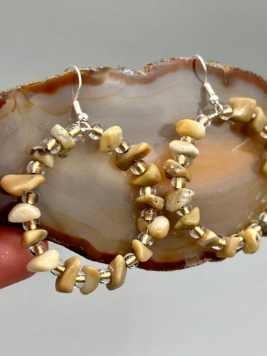 These lightweight Natural Bamboo Chip Beaded Hoop Earrings are perfect for any boho chic look. The combination of neutral colors and nature inspired design makes them the perfect accessory for any outfit. The glass beads add a subtle sparkle to complete the hippie vibe.  Measurements: 1 1/2