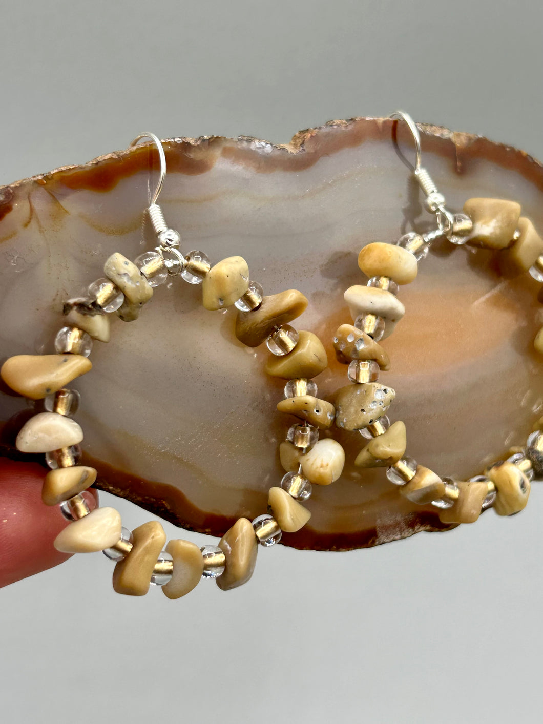 These lightweight Natural Bamboo Chip Beaded Hoop Earrings are perfect for any boho chic look. The combination of neutral colors and nature inspired design makes them the perfect accessory for any outfit. The glass beads add a subtle sparkle to complete the hippie vibe.  Measurements: 1 1/2