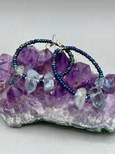 Load image into Gallery viewer, These ultra-trendy crystal nugget and glass beaded hoop earrings are perfect for any hippie or bohemian look. The dark blue glass beads give off an iridescent shimmer and blend brilliantly with the luster blue crystals, creating an eye catching contrast and a unique touch of nature-inspired beauty. Measurements: 2 1/4&quot; length

