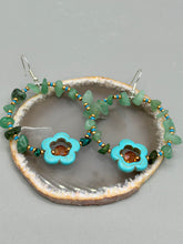Load image into Gallery viewer, This pair of earrings features a turquoise magnesite floral bead with a vibrant orange glass bead and natural green aventurine stone chips juxtaposed against gold and blue glass beads. Measurements: 2" length 
