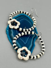 Load image into Gallery viewer, These handcrafted bohemian earrings combine an eye-catching white magnesite flower bead with a tiny hematite star bead, all charmingly displayed in a bone and glass beaded hoop. Perfect for adding a touch of hippie, shabby chic or boho chic vibes to your style. Measurements: 2" length  
