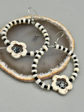 Load image into Gallery viewer, These handcrafted bohemian earrings combine an eye-catching white magnesite flower bead with a tiny hematite star bead, all charmingly displayed in a bone and glass beaded hoop. Perfect for adding a touch of hippie, shabby chic or boho chic vibes to your style. Measurements: 2" length  
