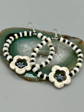 Load image into Gallery viewer, These handcrafted bohemian earrings combine an eye-catching white magnesite flower bead with a tiny hematite star bead, all charmingly displayed in a bone and glass beaded hoop. Perfect for adding a touch of hippie, shabby chic or boho chic vibes to your style. Measurements: 2" length  
