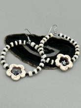 Load image into Gallery viewer, These handcrafted bohemian earrings combine an eye-catching white magnesite flower bead with a tiny hematite star bead, all charmingly displayed in a bone and glass beaded hoop. Perfect for adding a touch of hippie, shabby chic or boho chic vibes to your style. Measurements: 2" length  
