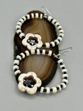 Load image into Gallery viewer, These handcrafted bohemian earrings combine an eye-catching white magnesite flower bead with a tiny hematite star bead, all charmingly displayed in a bone and glass beaded hoop. Perfect for adding a touch of hippie, shabby chic or boho chic vibes to your style. Measurements: 2" length  
