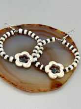 Load image into Gallery viewer, These handcrafted bohemian earrings combine an eye-catching white magnesite flower bead with a tiny hematite star bead, all charmingly displayed in a bone and glass beaded hoop. Perfect for adding a touch of hippie, shabby chic or boho chic vibes to your style. Measurements: 2" length  
