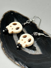 Load image into Gallery viewer, These stylish skull earrings are perfect for adding a unique flair to any outfit. Whether you&#39;re looking for a Dia De Los Muertos accessory or simply looking to draw inspiration, these goth pieces perfectly capture the vampire goth, witchy, dark, Chingona Cabrona, Latina Chicana styles.  Measurements: 1 1/4 ” in length
