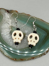 Load image into Gallery viewer, These stylish skull earrings are perfect for adding a unique flair to any outfit. Whether you&#39;re looking for a Dia De Los Muertos accessory or simply looking to draw inspiration, these goth pieces perfectly capture the vampire goth, witchy, dark, Chingona Cabrona, Latina Chicana styles.  Measurements: 1 1/4 ” in length
