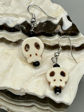 Load image into Gallery viewer, These stylish skull earrings are perfect for adding a unique flair to any outfit. Whether you&#39;re looking for a Dia De Los Muertos accessory or simply looking to draw inspiration, these goth pieces perfectly capture the vampire goth, witchy, dark, Chingona Cabrona, Latina Chicana styles.  Measurements: 1 1/4 ” in length

