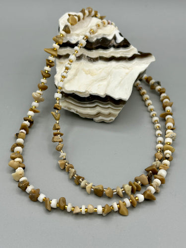 This natural bamboo, bone, and gold glass beaded necklace is the perfect piece to add versatility to any outfit. The neutral colors blend easily with any look and will give your outfit an unforgettable look. Measurements:   Necklace: 15