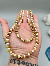Load image into Gallery viewer, This natural bamboo, bone, and gold glass beaded necklace is the perfect piece to add versatility to any outfit. The neutral colors blend easily with any look and will give your outfit an unforgettable look. Measurements:   Necklace: 15&quot; - can be adjusted up to 16&quot;
