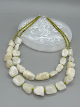 Load image into Gallery viewer, This exquisite necklace features large natural Calcite beads complemented by Wasabi Green glass beads. Two strands of neutral colors bring a sophisticated look that can dress up or dress down any outfit for a one-of-a-kind style.    Measurements:    Necklace is 17 1/4 &quot; in length adjustable to 18 1/2&quot;
