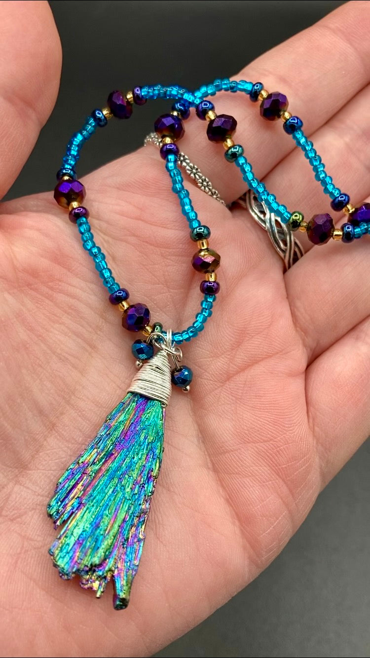 Rainbow Kyanite Wired Stone With Multi-Color Glass Beads Necklace. I used a combination of deep purples, turquoise blues, and golds to really capture the essence of this celestial galaxy stone. This beautiful necklace and rainbow kyanite pendant is a must have jewelry piece to add to your collection.  Measurements: Necklace is 16” adjustable up to 18