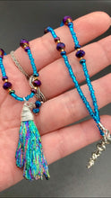 Load image into Gallery viewer, Rainbow Kyanite Wired Stone With Multi-Color Glass Beads Necklace. I used a combination of deep purples, turquoise blues, and golds to really capture the essence of this celestial galaxy stone. This beautiful necklace and rainbow kyanite pendant is a must have jewelry piece to add to your collection.  Measurements: Necklace is 16” adjustable up to 18&quot; in length - pendant is 2” Height
