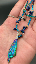 Load image into Gallery viewer, This celestial and galaxy goddess necklace features two strands of glass beading and a captivating Kyanite wired stone pendant. Its mixture of shimmering purples, blues, greens, and golds is truly striking and provides an alluring look like no other. Add this bold and beautiful jewelry piece to your collection today for a statement look that truly stands out. Necklace is 15” in length, can be adjusted to 18&quot;
