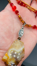 Load image into Gallery viewer, The Vibrant Yellow Agate Natural Stone Red Gold Beaded Choker Style Necklace is a fierce and bold statement piece. Featuring three strands of multi-color glass beads and a mixture of red and gold beads, this jewelry is a perfect addition to any collection. For a complete look, the merchant has created matching earrings. Necklace is 15” in length adjustable to 18" in length. Earrings are 1” length
