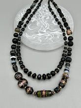 Load image into Gallery viewer, Add flair to your look with this unique large and chunky hand beaded necklace. Featuring a wide variety of mixed black glass beads in different sizes and shapes, this intricately-crafted statement piece offers a bold, hippie-chic, shabby-chic, and bohemian style.  Measurements:  Necklace is 18” in length, can be adjusted up to 20&quot;
