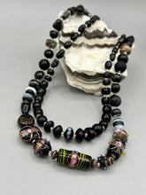 Load image into Gallery viewer, Add flair to your look with this unique large and chunky hand beaded necklace. Featuring a wide variety of mixed black glass beads in different sizes and shapes, this intricately-crafted statement piece offers a bold, hippie-chic, shabby-chic, and bohemian style.  Measurements:  Necklace is 18” in length, can be adjusted up to 20&quot;
